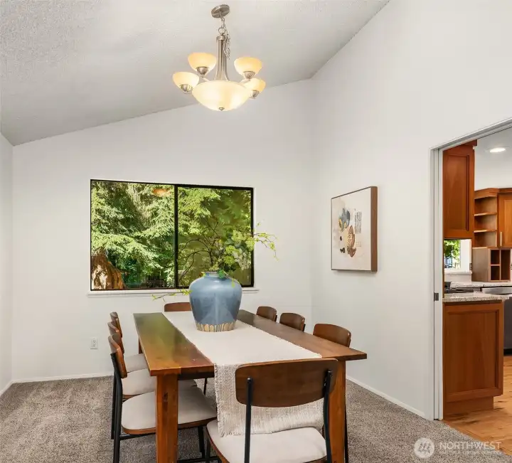 The dining room offers an updated light fixture and views to the backyard.