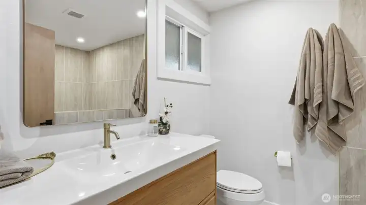 Enjoy a spa-inspired feel in the primary ensuite with its modern updates & soft lighting.