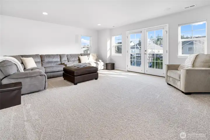 Large bonus/media room with built-in speakers and double doors to juliet balcony.