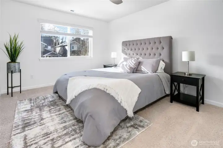 Upper level bedroom with closet built-ins.