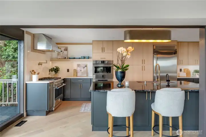 Seating at island, with pop-up outlet in island surface