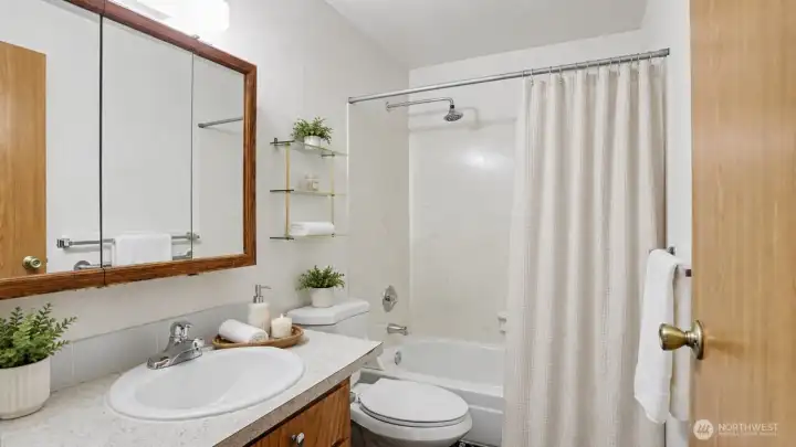 Shared bathroom with shower and bathtub.