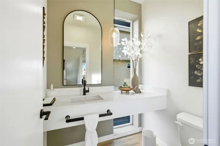 The convenient half bath on the main level is stunning with the floating vanity and large window.