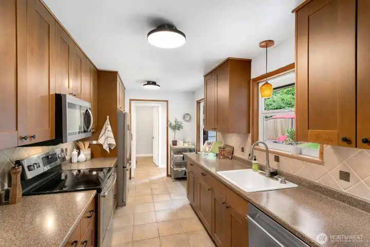 A spacious, oversized galley-style kitchen with abundant counter space, exceptional storage, and wide, comfortable walkways.