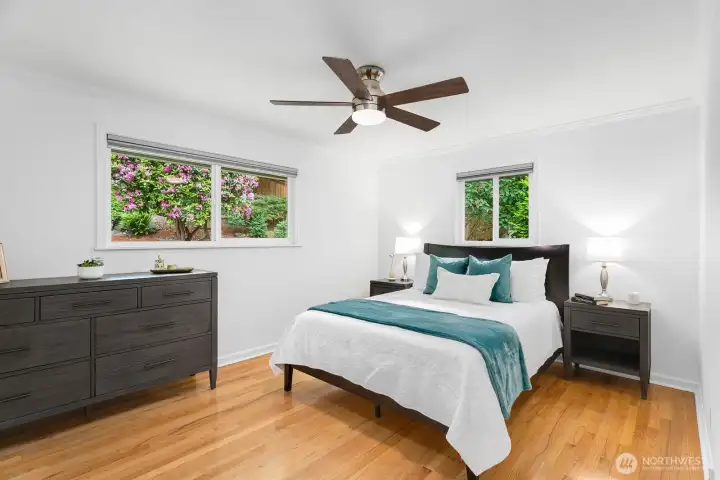 Positioned at the back of the home with garden views, the primary bedroom offers a peaceful setting.