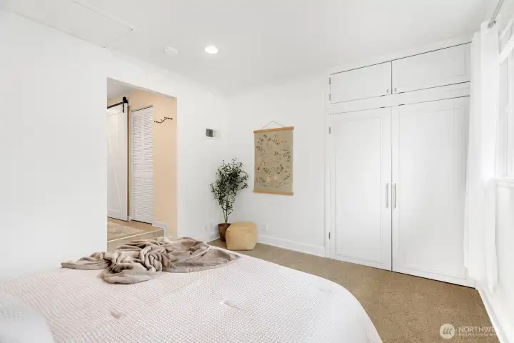 Double doors open to reveal a custom built-in closet.