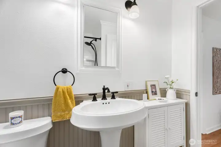 Updates in bathroom include tile floors and beadboard wainscoting detail.