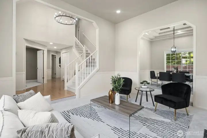 The sweeping staircase and open sightlines create a sense of grandeur throughout the main level, with the elegant chandelier and architectural details reinforcing the exceptional quality and craftsmanship found at every turn.