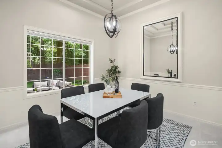 Another angle of the dining room showcases the generous proportions, stylish seating, and abundant natural light that make this space equally suited for intimate dinners or larger entertaining occasions.