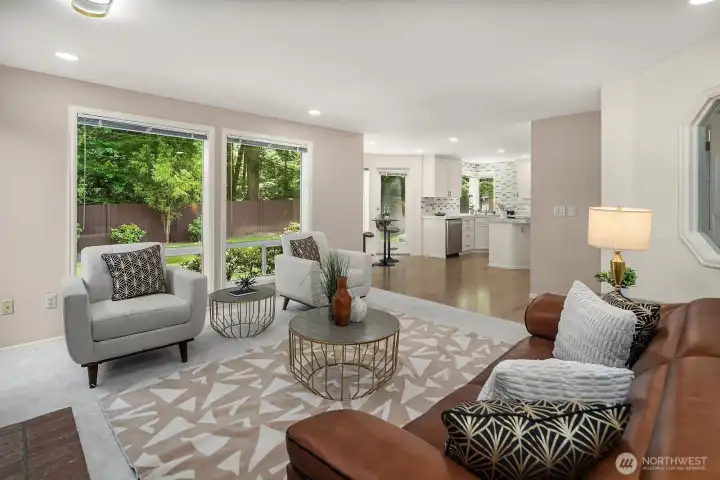 This angle captures the seamless connection between the family room and the rest of the main level, with large windows pulling in greenery from the backyard and reinforcing the bright, open flow that defines this home.