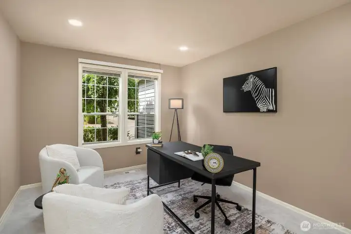The dedicated main-level office offers a quiet, well-lit workspace with a large window and neutral finishes, providing the ideal setup for working from home without sacrificing comfort or style.