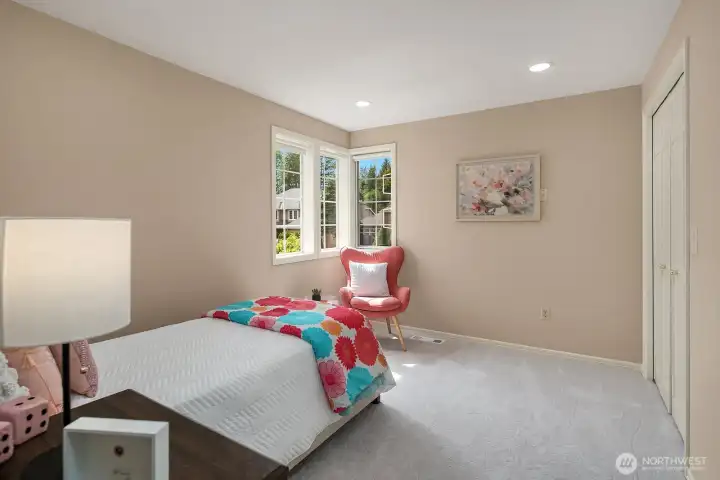 Another generously sized secondary bedroom features the same quality finishes and natural light found throughout the home, offering a comfortable and inviting space that adapts easily to a variety of needs.