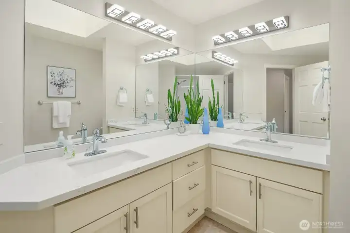 The full upper-level bath features a dual-sink vanity with generous counter space and bright lighting, providing a well-appointed and practical space that serves the secondary bedrooms with ease.