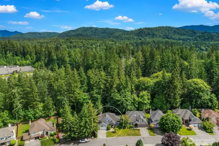 Another aerial perspective captures the stunning natural setting of the Klahanie community, with the Issaquah foothills and endless evergreen canopy creating a breathtaking backdrop that makes this location truly one of a kind.