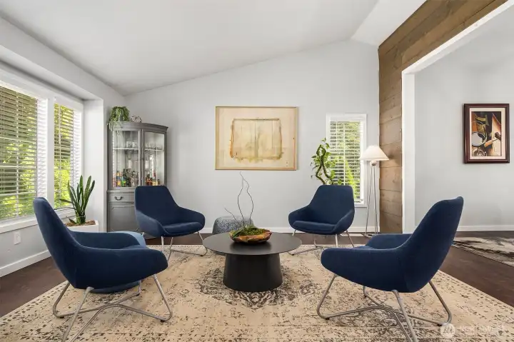 The living room welcomes everyone to take a seat. Vaulted ceilings and tasteful updates.