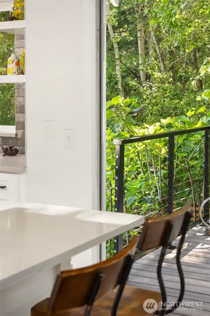 Kitchen and family room access the expansive low maintenance deck.
