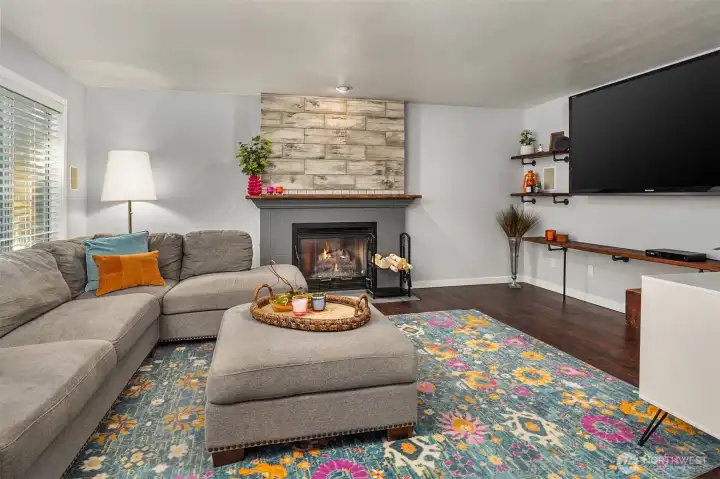 Family room with cozy wood burning fireplace for those cooler fall and winter days.