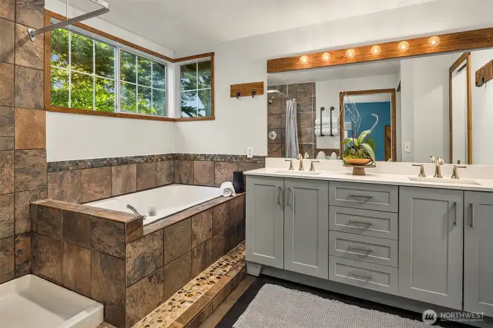Primary bathroom with shower, soaking tub, dual vanity and walk-in-closet.