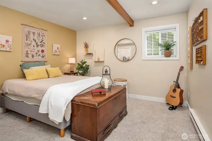 One of two bright lower bedrooms with wood beam.