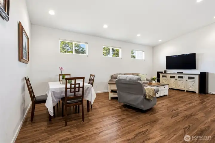 Large Living Room / Dining area with vaulted ceilings and remote operated blinds