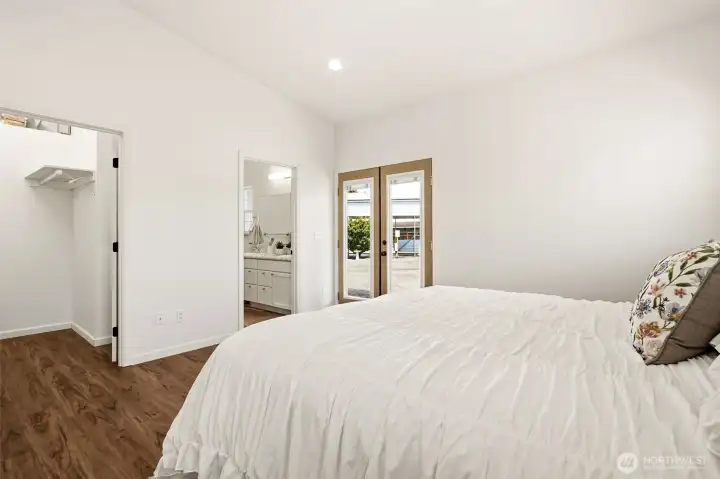 Primary Bedroom with vaulted ceilings and French doors to the  covered porch