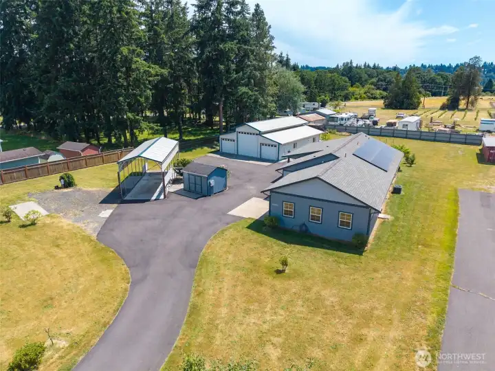 RV Spots, Well House, 1,920 sf shop and custom-built 1-story home on a flat 1-acre lot!