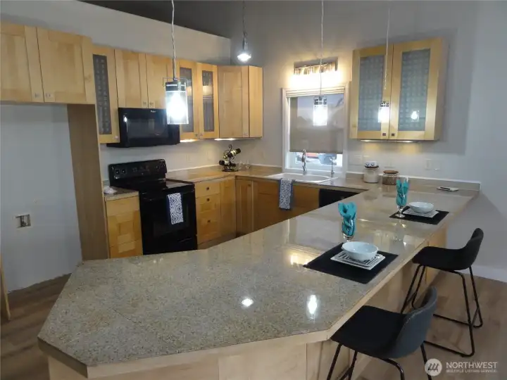 Country style kitchen with plenty of cabinets and eating bar