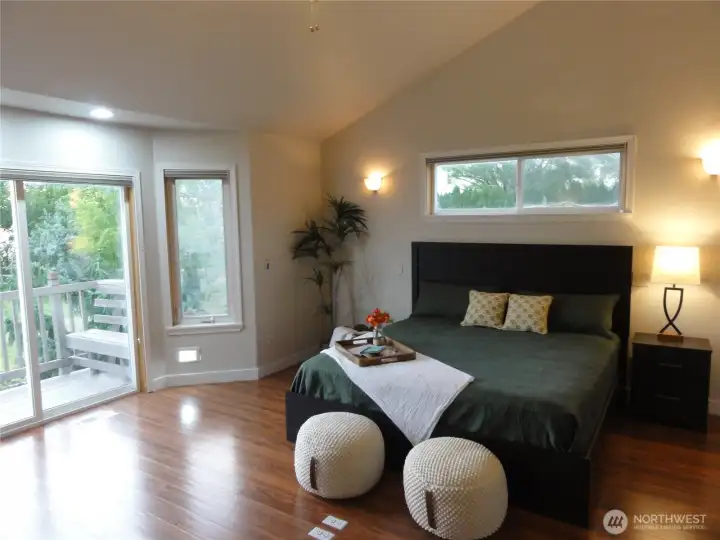 Primary bedroom with its own bathroom and deck for views of the lake.