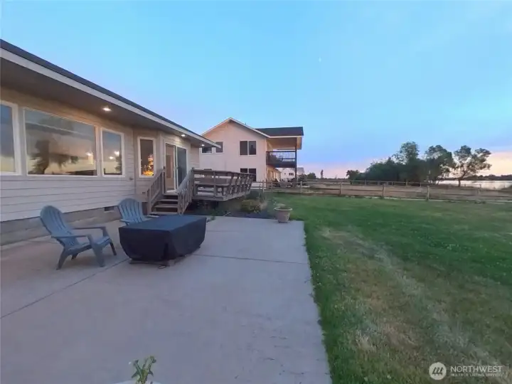 Back of home with patio and fire table for afternoon relaxing!