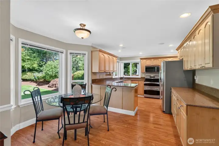 Great room with informal eating area, kitchen with solid surface counters all adjacent to living space with outdoor access to private patio and fenced yard Great room with informal eating area, kitchen with solid surface counters all adjacent to living space with outdoor access to private patio and fenced yard