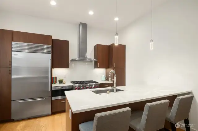 This kitchen is a chefs dream, with Subzero refrigerator and Wolf appliance package. Beautiful subway tile backsplash and solid quartz counter/casual dining space complete the dream.