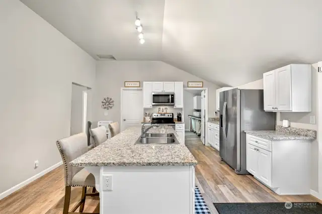 Main kitchen with large granite island.