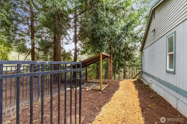 Fenced dog or chicken run is a safe haven for your beloved pets.