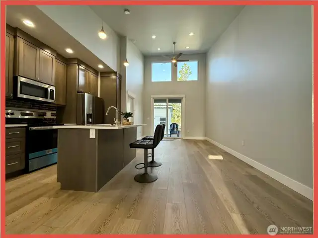 Enter the bright and airy great room with double-height ceilings and a sliding door leading to the covered deck and fully fenced back yard complete with 10x12’ shed.