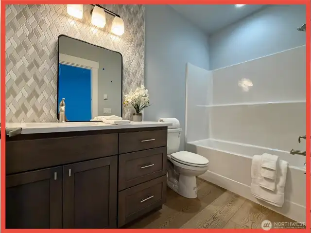 Full bathroom next to bedroom #1. 9’ ceilings in beds/baths.