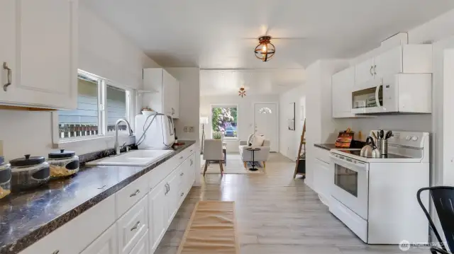 The kitchen shines with freshly painted walls, complementing the spacious layout and offering a bright, welcoming atmosphere throughout the entire home