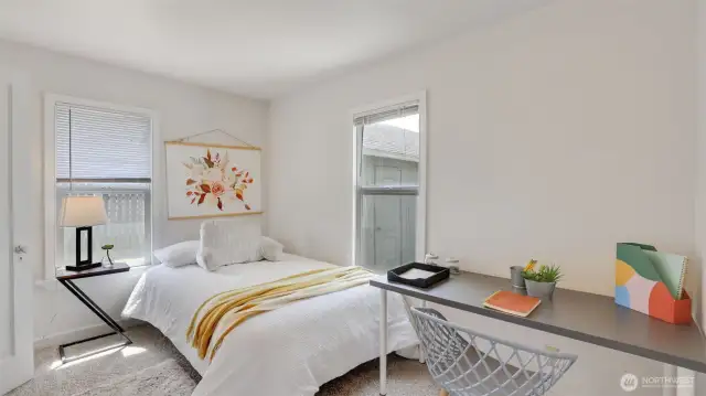 This secondary bedroom offers plenty of natural light and flexible space—perfect for a guest room or a home office