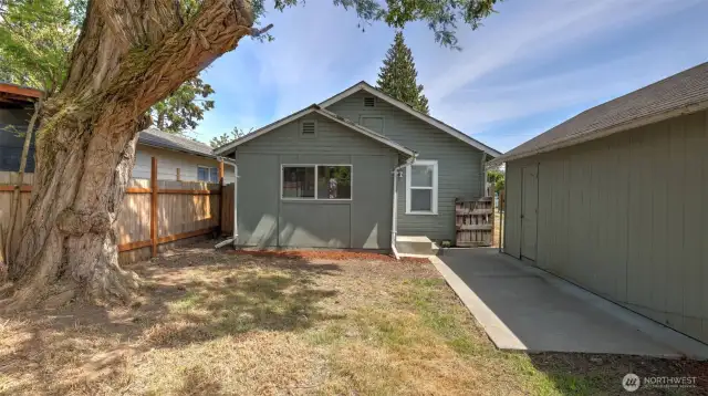 The back view of the house offers a peaceful setting with plenty of outdoor space, perfect for unwinding or hosting gatherings