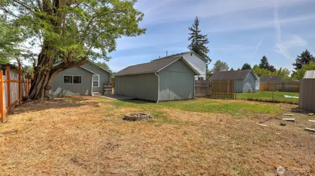 Appreciate a large backyard with plenty of room for outdoor activities, featuring a handy shed tucked in the corner for extra storage