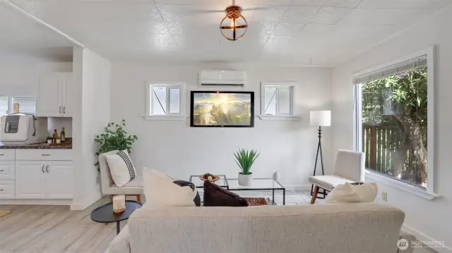 The living room effortlessly flows into the dining area and kitchen, creating an ideal space for gatherings and seamless entertaining