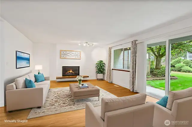 Living room with fireplace and views of gardens