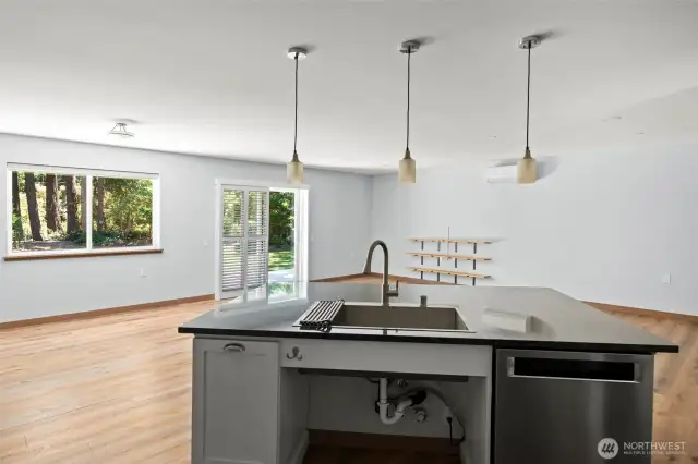 Extra large, deep sink and a breakfast bar on this very large and functional kitchen island.