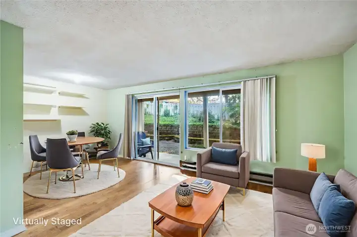 Generous natural light comes into the home from the sliding glass door and large living room windows! (home is virtually staged in this photo)