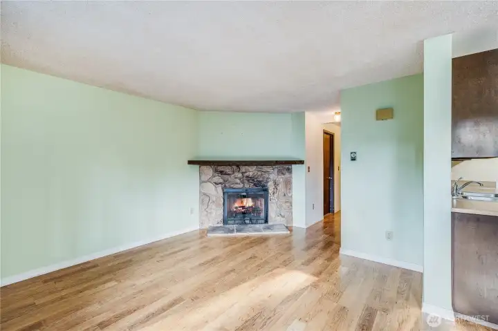 The fireplace offers a cozy source of heat during cooler winter months.