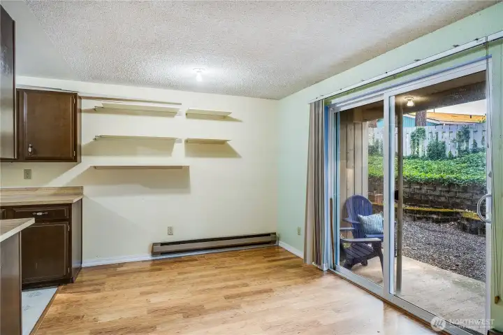 Convenient shelves on the dining room wall can hold cookbooks, decor, or special photos.