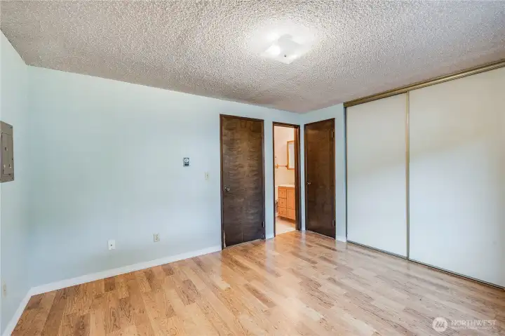 The bedroom features an extra sized closet and a private door into the bathroom.