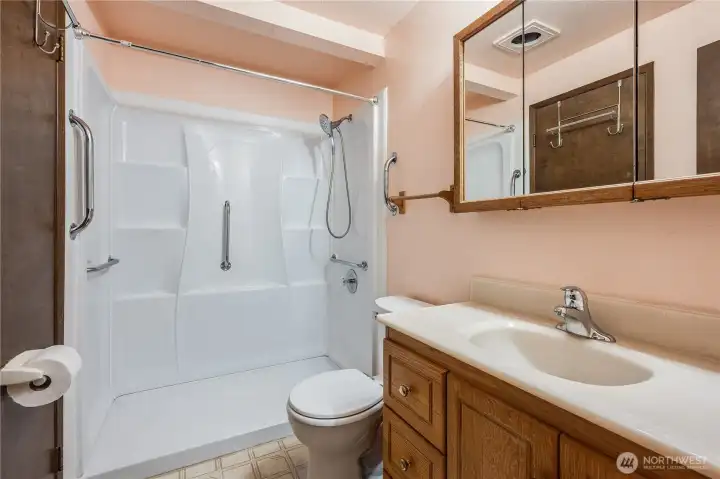 Bathroom storage is available in the spacious vanity and behind the mirror.
