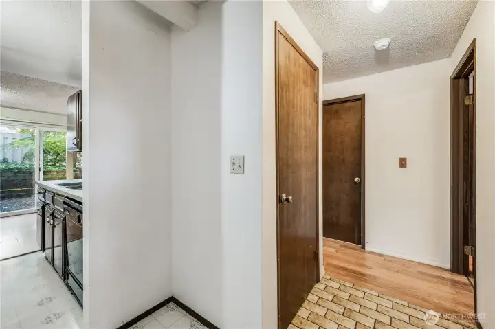 This view shows the entryway inside the condo, with the kitchen to the left and a coat closet located just ahead.