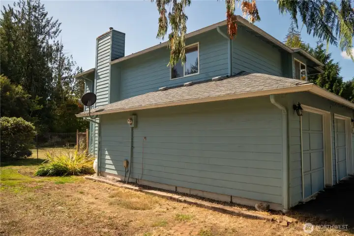 Side view with back yard to left. Leaf guard gutters add to the ease of care for this well appointed home.