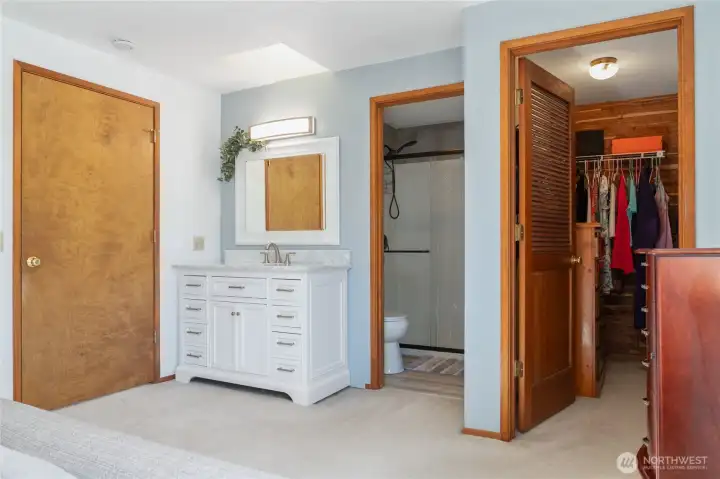 Primary suite w/ walk in cedar closet and newly remodeled bathroom.Thoughtfully designed with a bedroom vanity and sink, the primary suite balances elegance and practicality, allowing seamless shared use of the space.